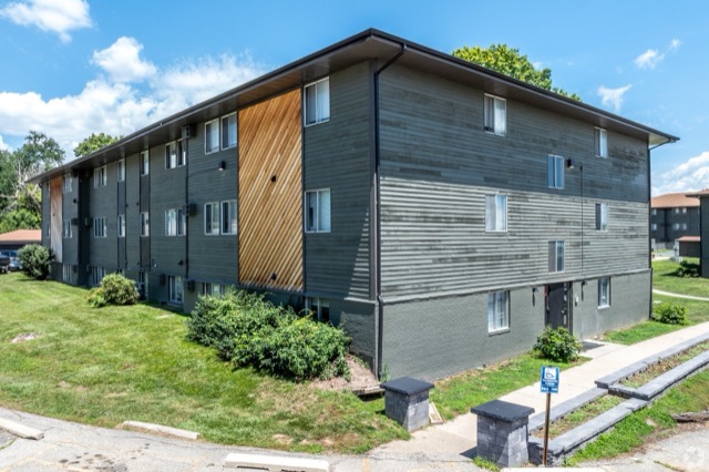 Building at The Oaks: grey siding with a cedar accent panel